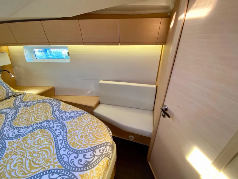 Slide: The Image of Luxurious cabin interior of 2016 Jeanneau 54 yacht with elegant bedding and seating. - 37