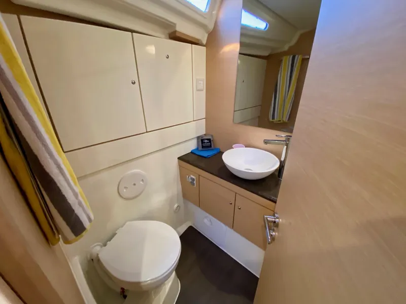 Slide: The Image of Bathroom interior of 2016 Jeanneau 54 yacht with modern fixtures and storage cabinets. - 39