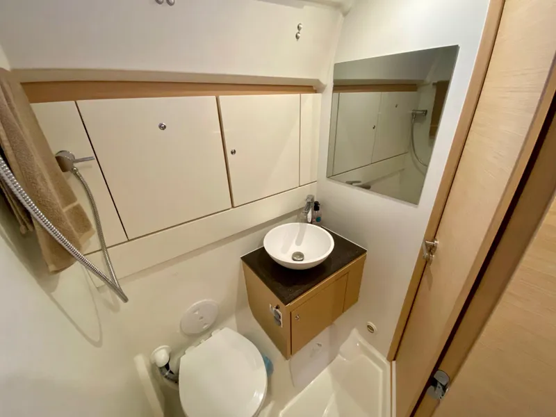 Slide: The Image of Compact bathroom in a 2016 Jeanneau 54 yacht with modern fixtures and storage. - 46