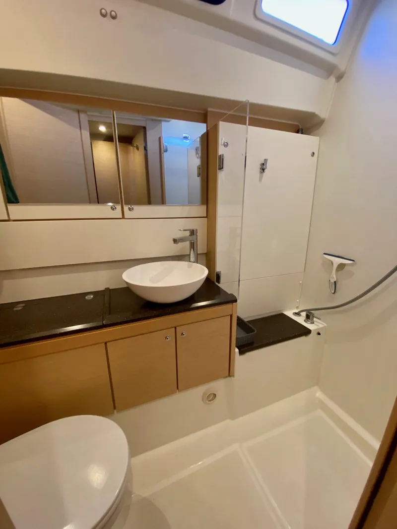 Slide: The Image of Modern bathroom in a 2016 Jeanneau 54 yacht with sleek fixtures and ample storage. - 48