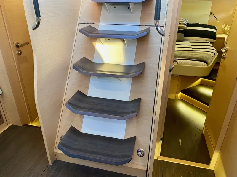 Slide: The Image of Interior stairs of a 2016 Jeanneau 54 yacht, leading to a cozy cabin. - 49