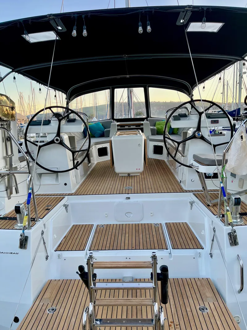 Slide: The Image of 2016 Jeanneau 54 sailboat cockpit with dual steering wheels and teak decking. - 6