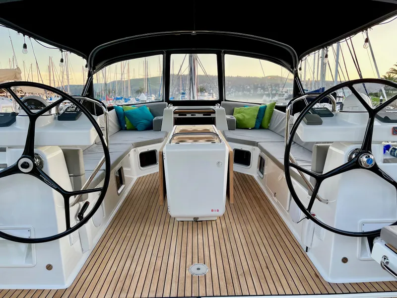 Slide: The Image of Luxurious 2016 Jeanneau 54 yacht cockpit with dual steering wheels and elegant seating. - 7