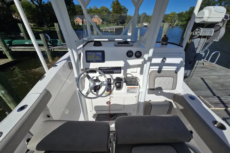 Slide: The Image of 2022 Sea Fox 249 Avenger boat cockpit with steering wheel and navigation system. - 22