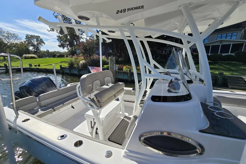 Slide: The Image of 2022 Sea Fox 249 Avenger boat docked by a scenic waterfront. - 3