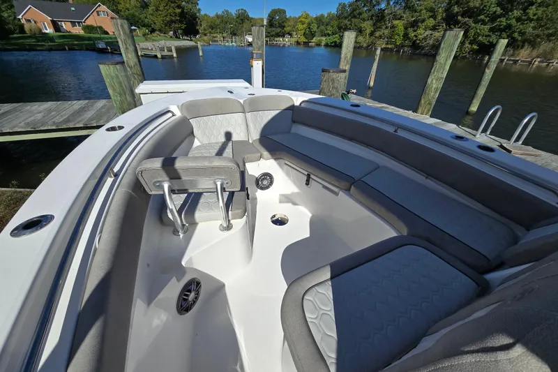 Slide: The Image of 2022 Sea Fox 249 Avenger boat interior with cushioned seating, docked by a serene lake. - 33