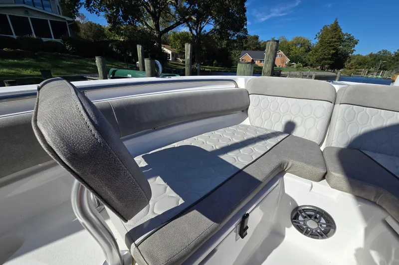 Slide: The Image of 2022 Sea Fox 249 Avenger boat interior with gray cushioned seating and speaker. - 34