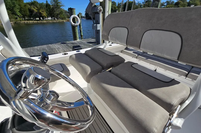 Slide: The Image of 2022 Sea Fox 249 Avenger boat interior with steering wheel and cushioned seating. - 43