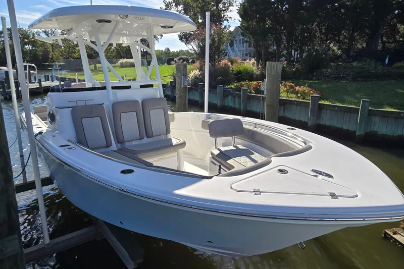 Slide: The Image of 2022 Sea Fox 249 Avenger boat docked, featuring sleek design and spacious seating. - 8