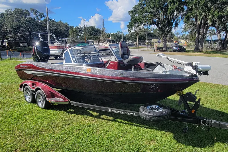 The Image of 2018 Ranger 2080MS Angler boat on trailer, parked on grass under clear sky. - 0