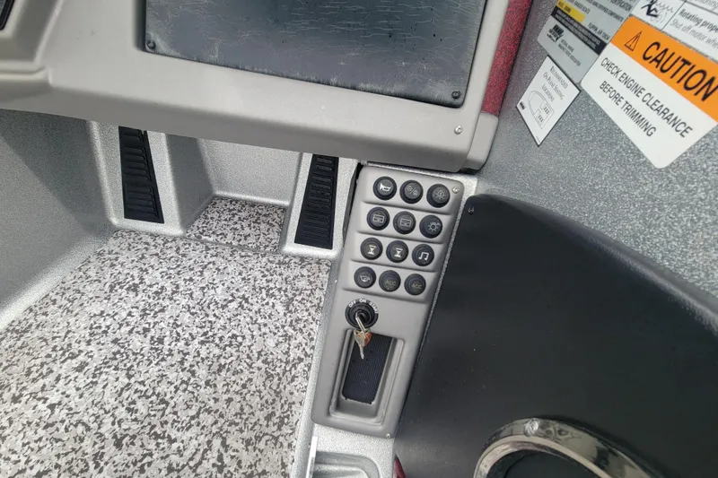 Slide: The Image of Control panel of 2018 Ranger 2080MS Angler boat with key ignition and caution labels. - 12