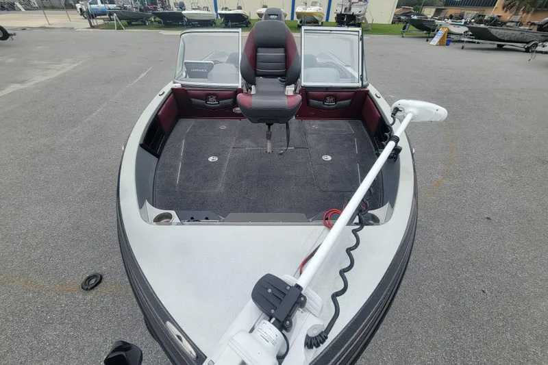 Slide: The Image of 2018 Ranger 2080MS Angler boat with trolling motor and seating, parked outdoors. - 14