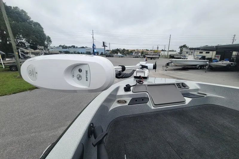 Slide: The Image of 2018 Ranger 2080MS Angler boat with Minn Kota Riptide trolling motor in a marina setting. - 15