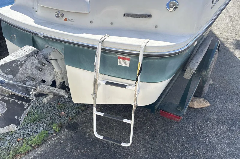 Slide: The Image of 2001 Four Winns 180 Horizon boat with ladder and trailer, rear view. - 15