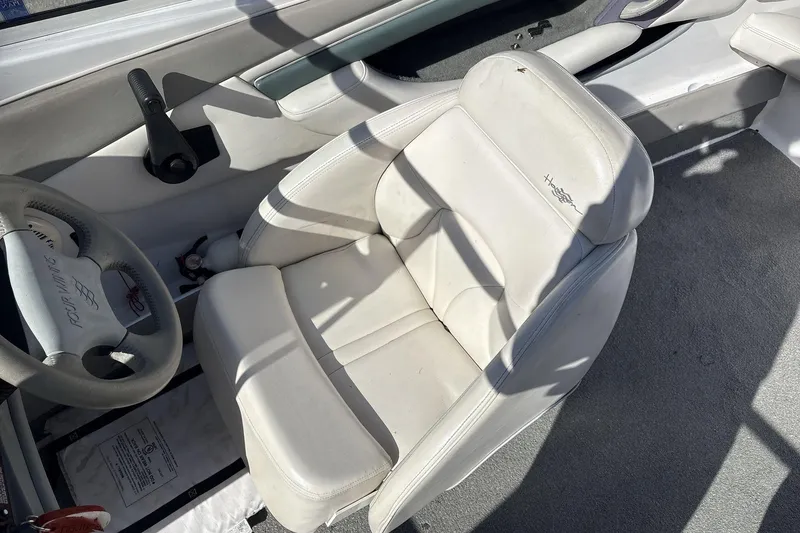 Slide: The Image of 2001 Four Winns 180 Horizon boat interior with white seating and steering wheel. - 7