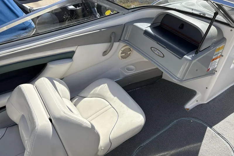 Slide: The Image of 2001 Four Winns 180 Horizon boat interior with white seating and dashboard. - 8