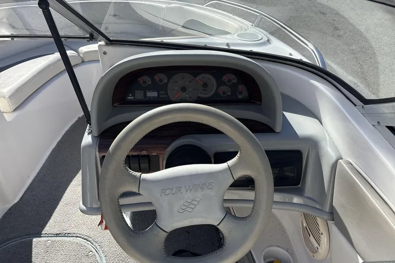 Slide: The Image of 2001 Four Winns 180 Horizon boat dashboard with steering wheel and instrument panel. - 9