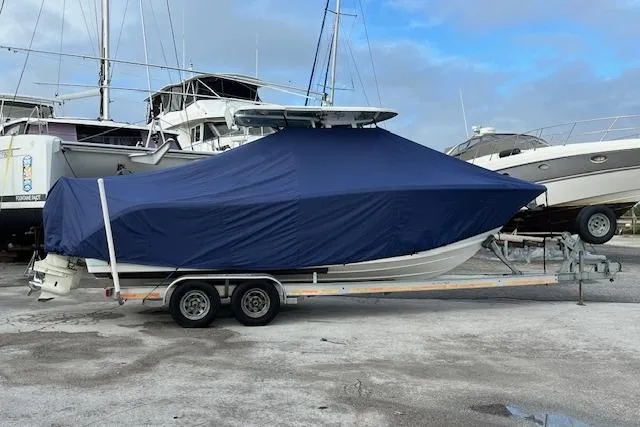 Slide: The Image of 2019 Sea Pro 259 Center Console boat covered on trailer, docked in marina. - 12