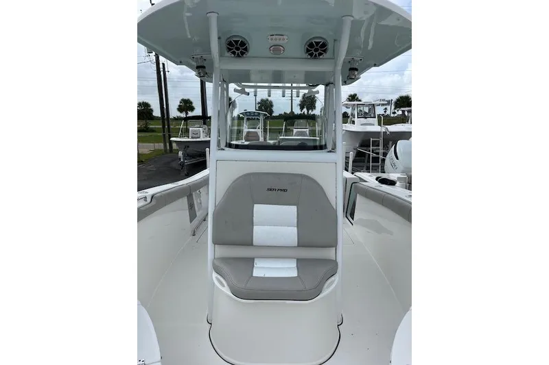 Slide: The Image of 2019 Sea Pro 259 Center Console boat with cushioned seating and overhead speakers. - 7