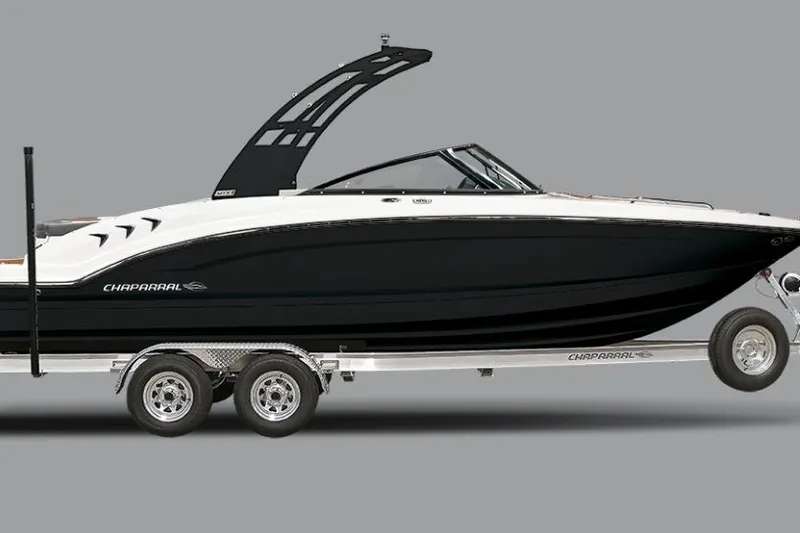 Slide: The Image of 2026 Chaparral 23 SSi OB boat on trailer, sleek black and white design. - 13