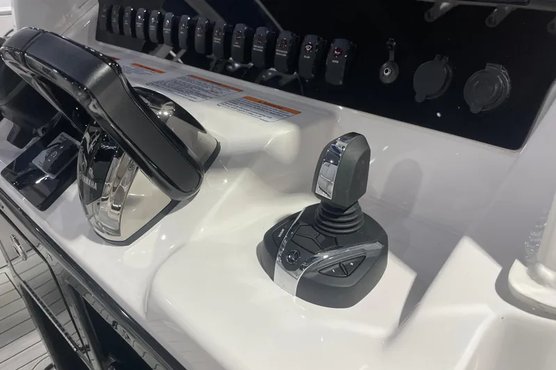 Slide: The Image of Yamaha Boats 2025 255 FSH Sport H control panel with joystick and throttle. - 11