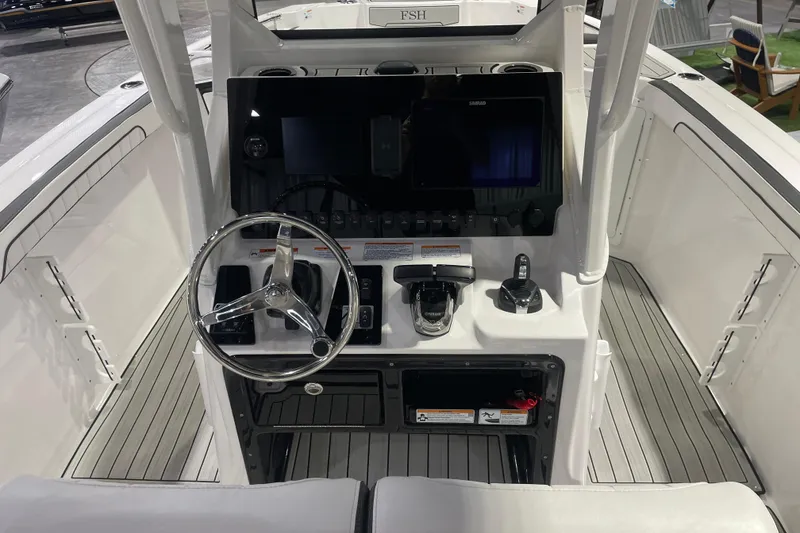 Slide: The Image of 2025 Yamaha Boats 255 FSH Sport H helm with modern controls and sleek design. - 6