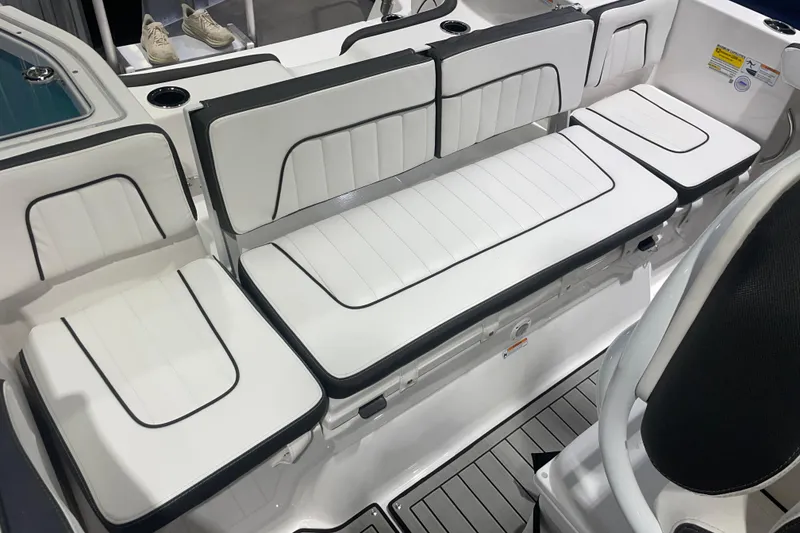 Slide: The Image of 2025 Yamaha Boats 255 FSH Sport H interior seating with white upholstery and black trim. - 8