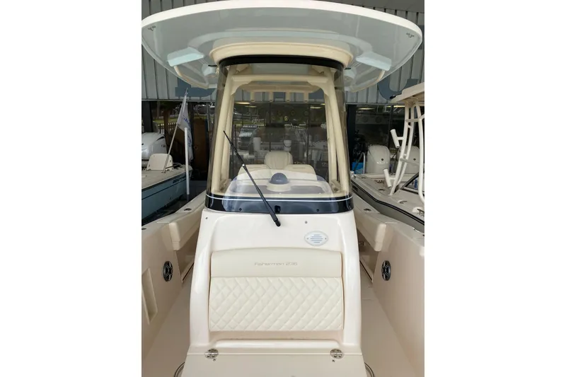 Slide: The Image of 2026 Grady-White Fisherman 236 boat, front view, showcasing helm and seating area. - 10