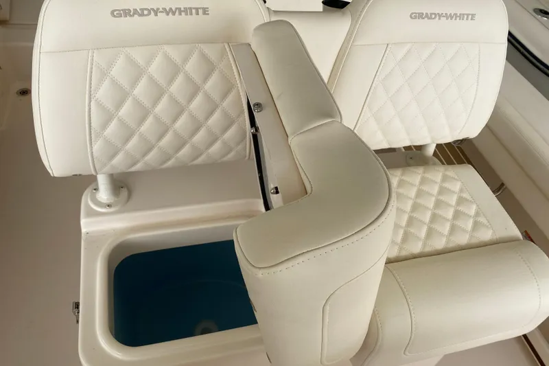 Slide: The Image of 2026 Grady-White Fisherman 236 boat seats with diamond stitching and storage compartment. - 14