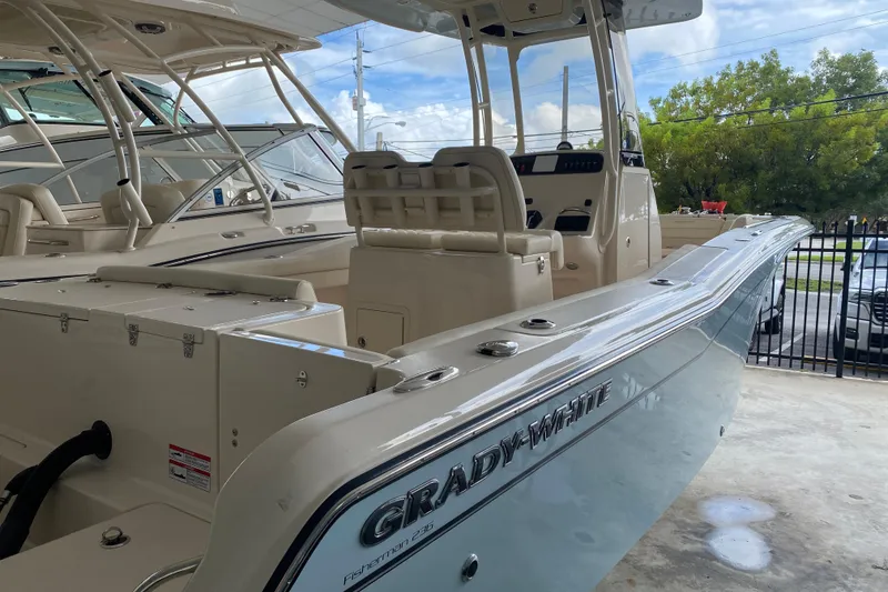 Slide: The Image of 2026 Grady-White Fisherman 236 boat, sleek design, spacious interior, parked in marina. - 3
