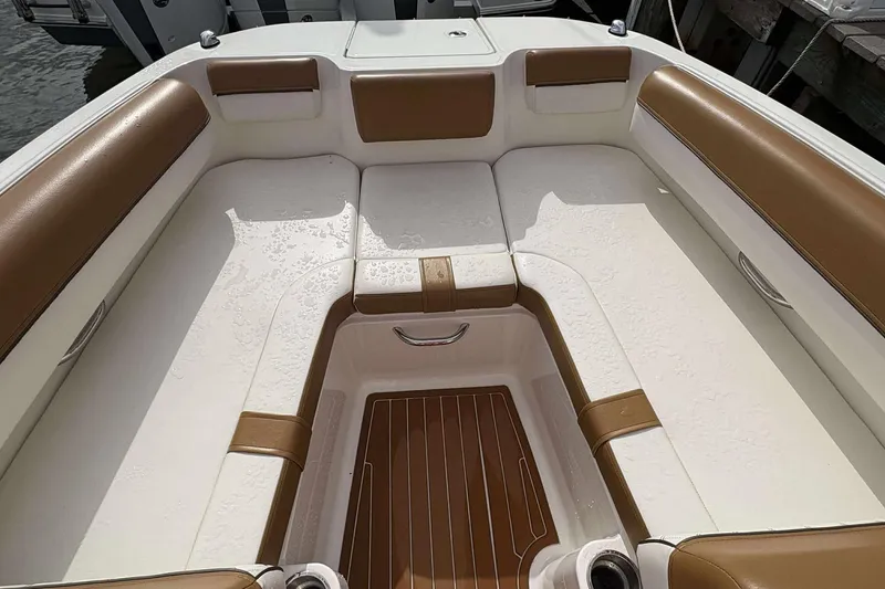 Slide: The Image of Interior seating of a 2021 Bayliner DX 2000 boat with brown and white upholstery. - 10