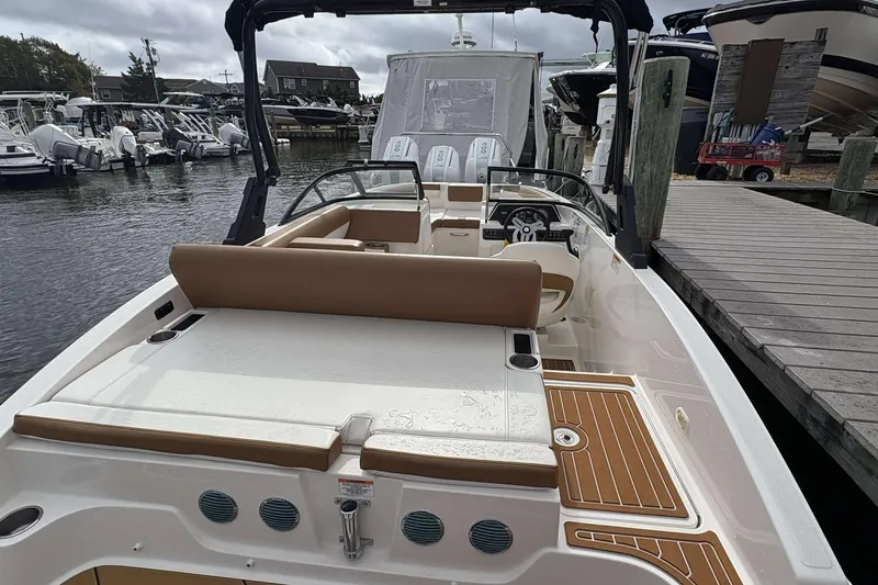 Slide: The Image of 2021 Bayliner DX 2000 boat docked, featuring spacious seating and modern design. - 13