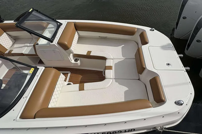 Slide: The Image of 2021 Bayliner DX 2000 boat with spacious seating and elegant design on the water. - 6