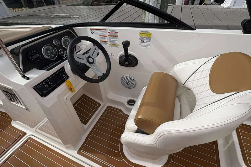 Slide: The Image of 2021 Bayliner DX 2000 boat interior with steering wheel and captain's seat. - 7