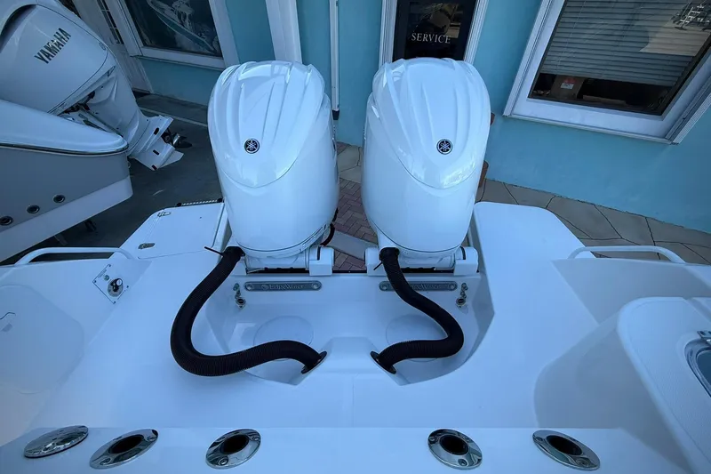 Slide: The Image of Edgewater 250CC boat with dual Yamaha outboard engines, 2026 model, docked near service area. - 11