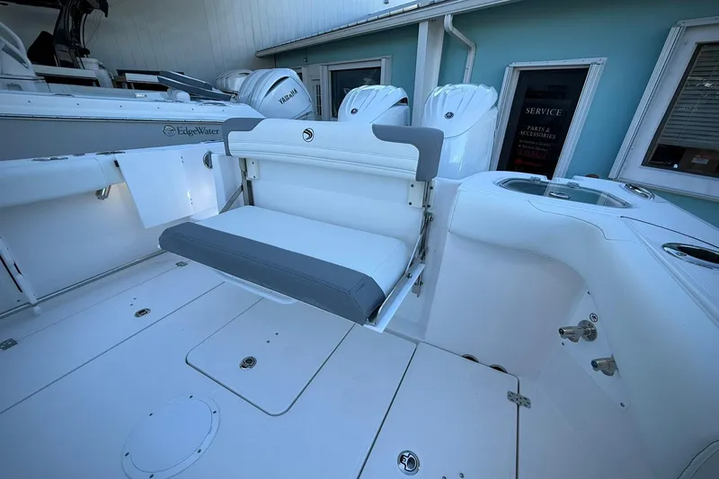 Slide: The Image of 2026 Edgewater 250CC boat interior with foldable seat and Yamaha engines in a showroom. - 16