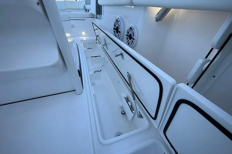 Slide: The Image of 2026 Edgewater 250CC boat interior with open storage compartments and speakers. - 18