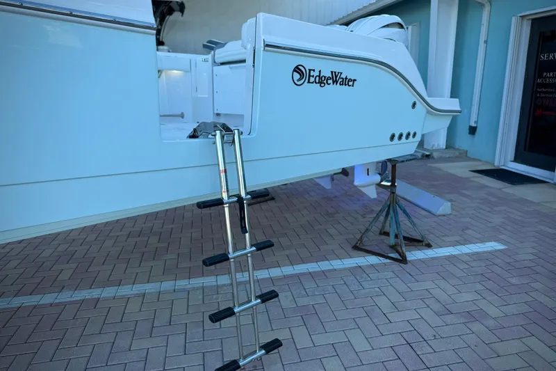 Slide: The Image of 2026 Edgewater 250CC boat with ladder on brick pavement. - 2