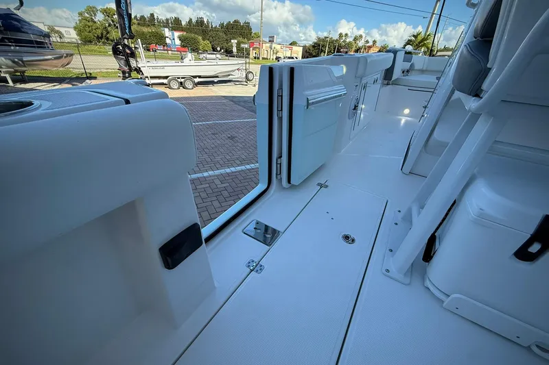 Slide: The Image of 2026 Edgewater 250CC boat interior with open door, showcasing sleek white design. - 20