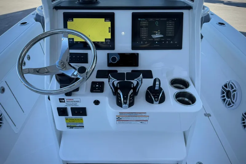 Slide: The Image of 2026 Edgewater 250CC boat console with steering wheel, digital displays, and controls. - 24