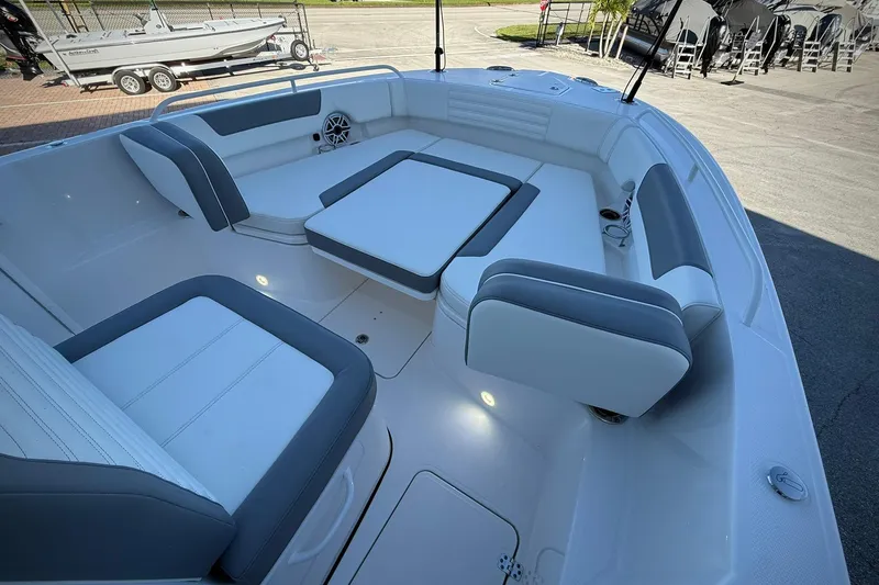 Slide: The Image of 2026 Edgewater 250CC boat interior with cushioned seating and modern design. - 32