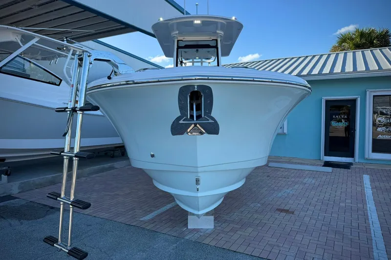 Slide: The Image of 2026 Edgewater 250CC boat displayed outdoors with ladder and blue building background. - 6