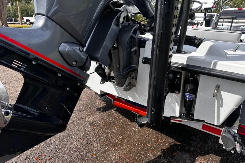 Slide: The Image of 2022 Maverick 17 HPX-V boat engine and transom detail, parked on wet pavement. - 12