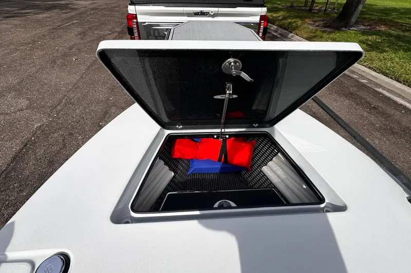 Slide: The Image of Open storage compartment of 2022 Maverick 17 HPX-V boat, showing interior details. - 13