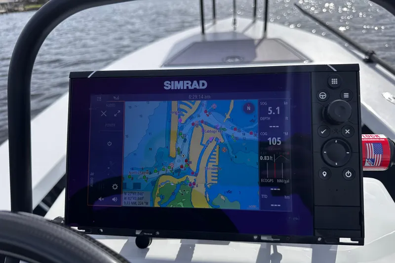 Slide: The Image of Simrad navigation display on 2022 Maverick 17 HPX-V boat, showing nautical map and data. - 16
