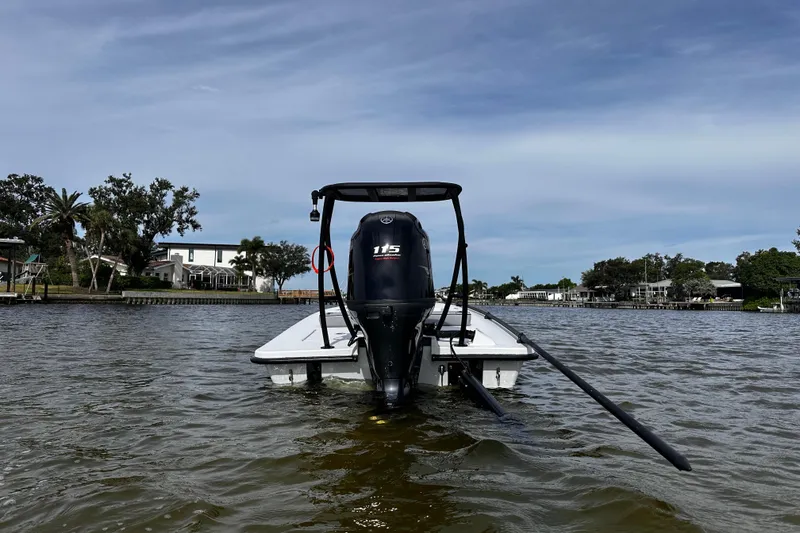 Slide: The Image of 2022 Maverick 17 HPX-V boat on water, rear view with outboard motor. - 2