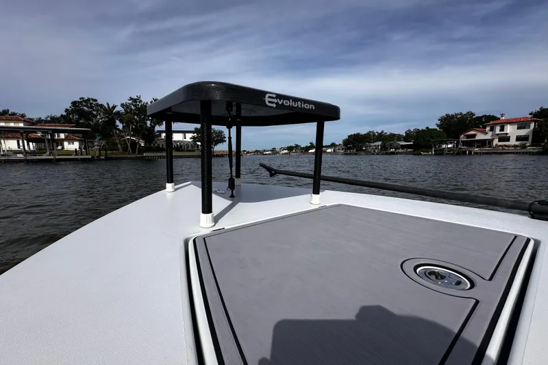 Slide: The Image of 2022 Maverick 17 HPX-V boat on water, featuring Evolution platform, scenic waterfront view. - 21