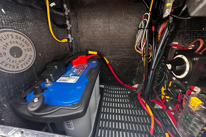 Slide: The Image of 2022 Maverick 17 HPX-V boat battery compartment with wiring and connections. - 26