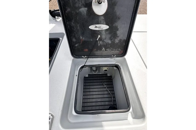Slide: The Image of Open storage compartment on 2022 Maverick 17 HPX-V boat, featuring a carbon fiber lid. - 27