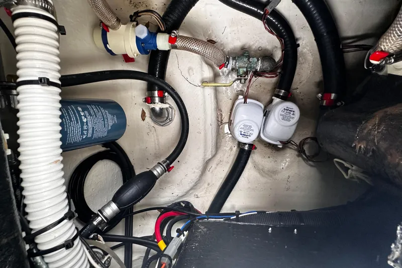 Slide: The Image of 2022 Maverick 17 HPX-V boat interior showing bilge pump and wiring setup. - 28